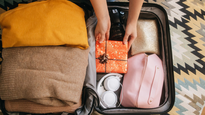 Someone neatly packing a suitcase ready to go on vacation