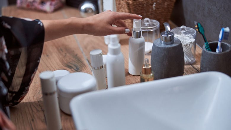Someone tidying their bathroom counter