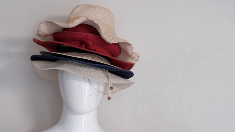 A mannequin head wearing a hat