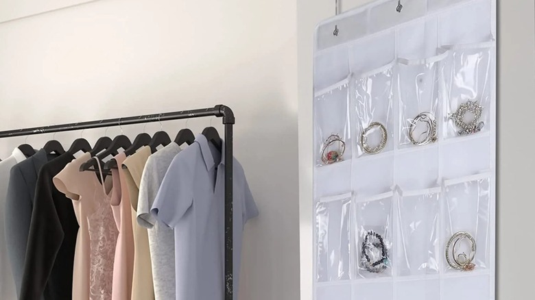 An over-the-door organizer holding jewelry