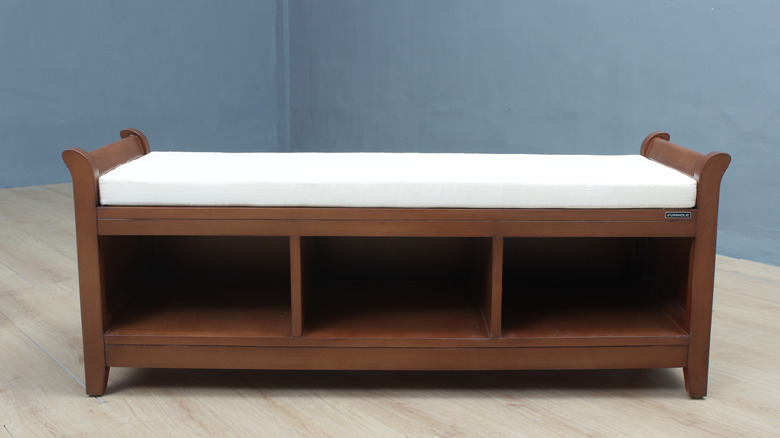 A wooden bench with shoe cubbies