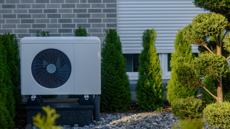 An air-source heat pump in a beautifully landscaped garden