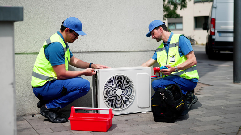 Technicians working on a heat pump