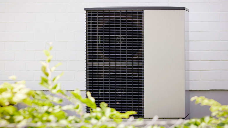An air-source heat pump outside of a house