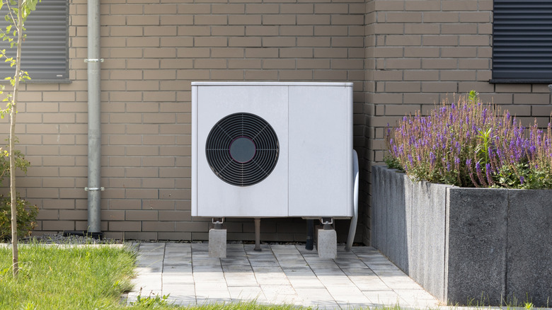 A heat pump installed in a quiet corner of a garden, away from social areas