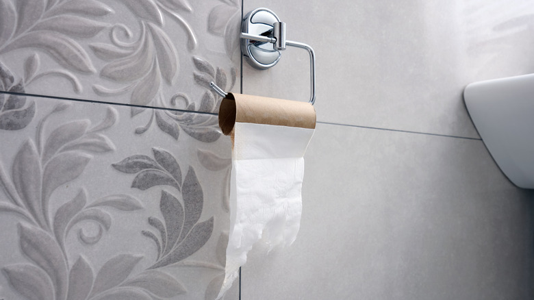 Toilet paper holder with empty roll