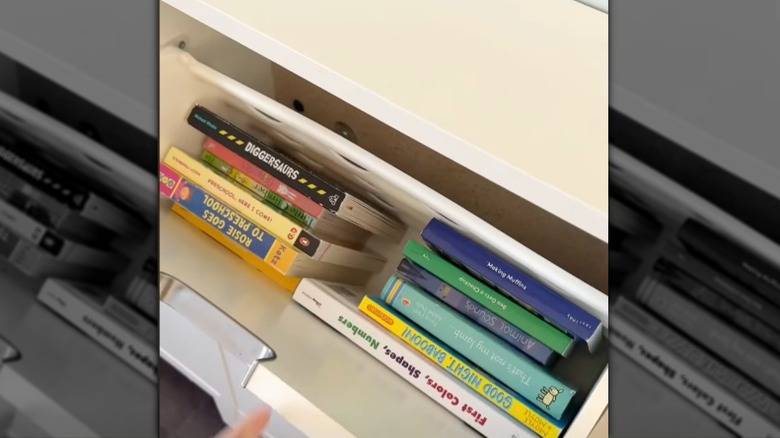 Tilt out shoe cabinet used to store books