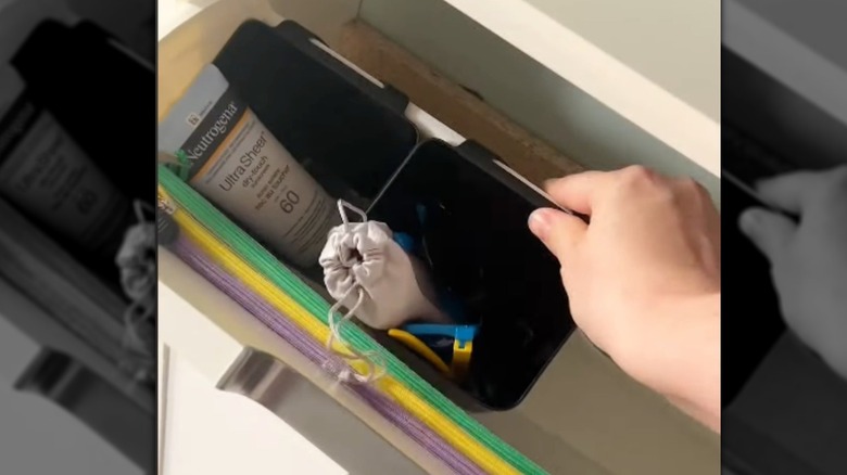 tilt out drawer with various items