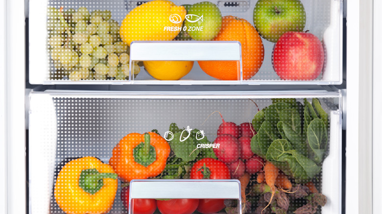 Fresh vegetables and fruits in drawers of refrigerator