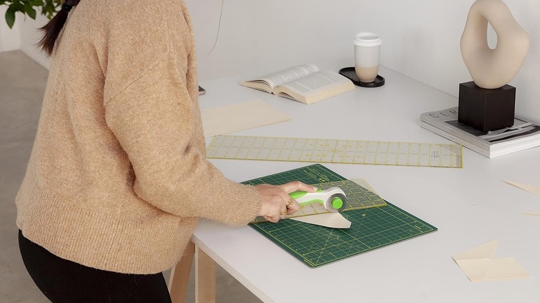 Woman using green cutting mat for crafting project
