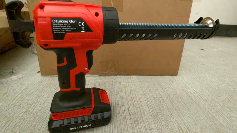 woman using caulk gun