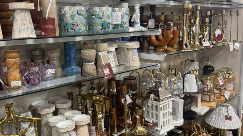 An aisle of candlesticks and candle holders at HomeGoods