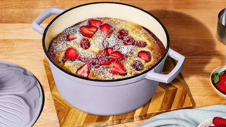 A lavender Dutch oven with a strawberry dessert
