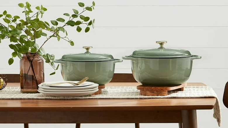 Two Dutch ovens sitting on a dinner table