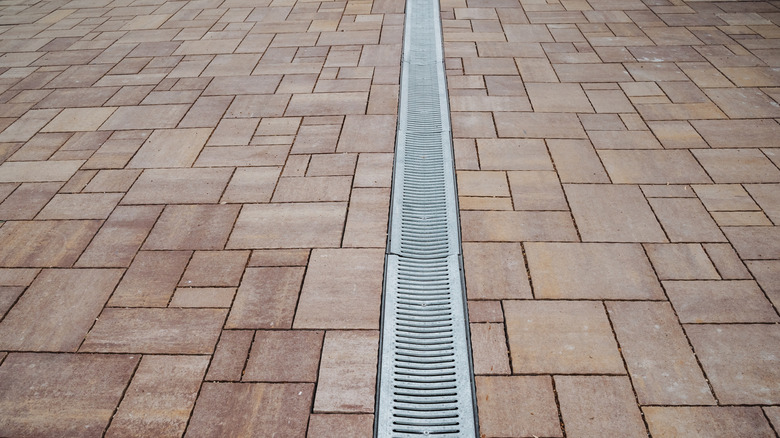 A brick driveway with drainage grids