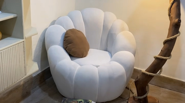 White plush tire chair beside wood lamp in room corner