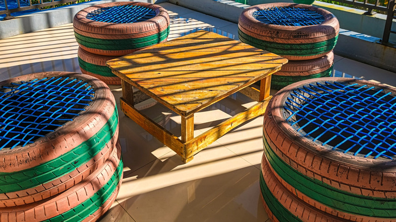 Funky tire chairs around outdoor wood table on patio