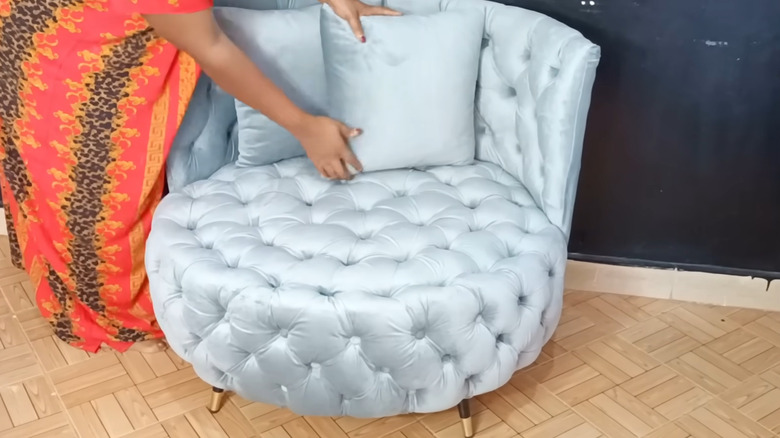 Plush shiny tufted armchair made from a tire