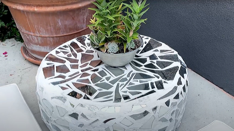 Mosaic tire table with succulent bowl outdoors