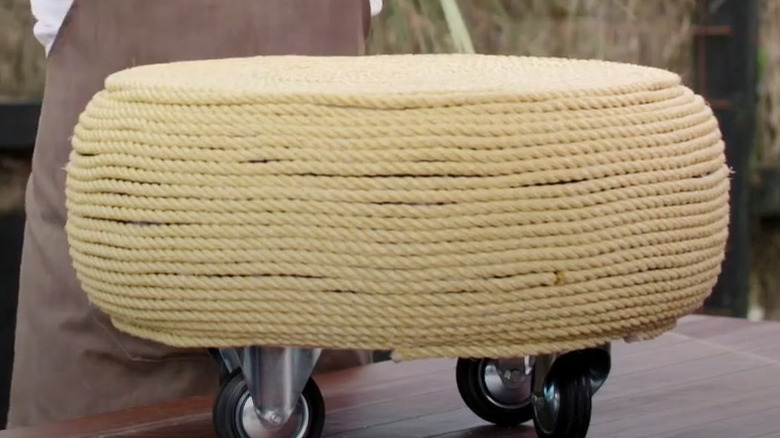 Rope-covered tire ottoman on wheels