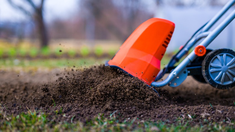 An aerator breaking up compacted soil