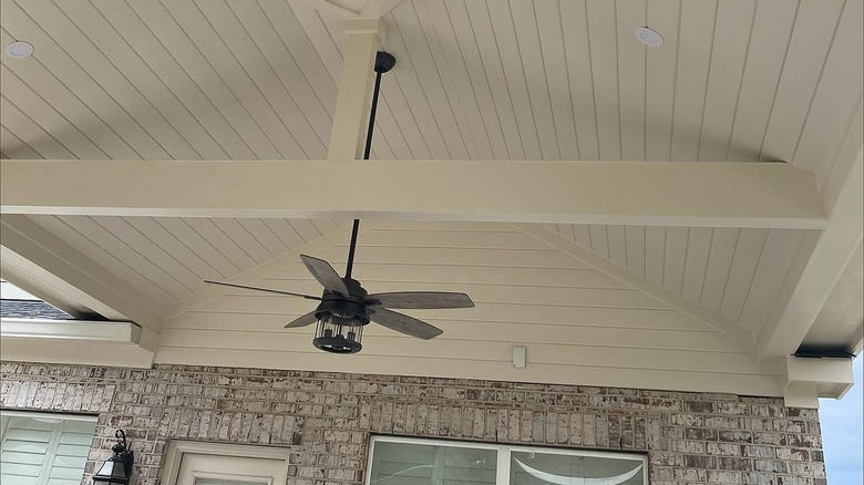 Patio ceiling painted in off-white with a ceiling fan.