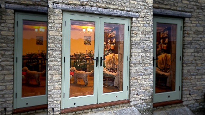 Double patio doors with glass painted in a soft blue-green.