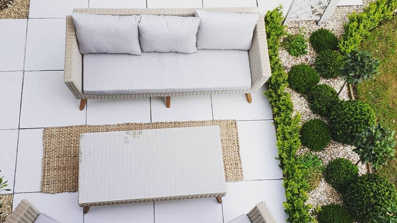 Overhead view of a patio with old tiles painted white to refresh them.