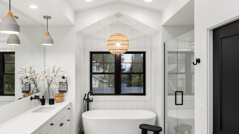 Natural material sphere light above bathtub
