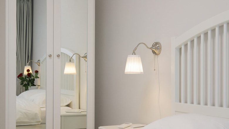 Bedside sconce lighting with white shade
