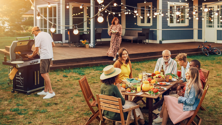 outdoor party in a backyard with a barbeque