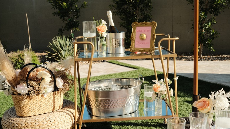 outdoor bar cart with champagne and a metal tub