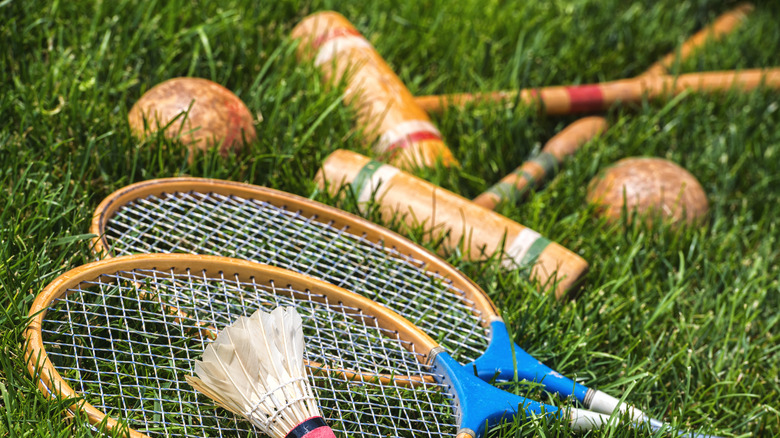 Badminton and croquet equipment on grass