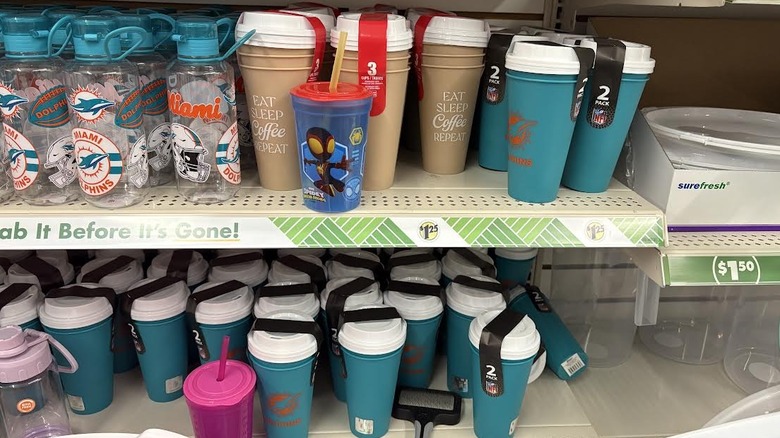 Dollar store plastic mugs and lids scattered on store shelf