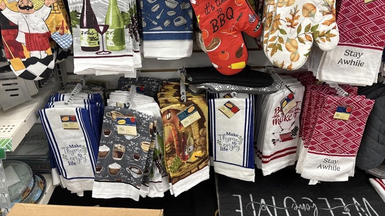 Kitschy dollar store kitchen towels featuring sayings and illustrations