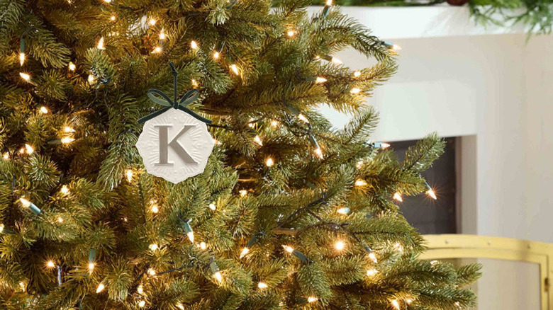 Ceramic snowflake monogram Christmas ornament hanging on a Christmas tree