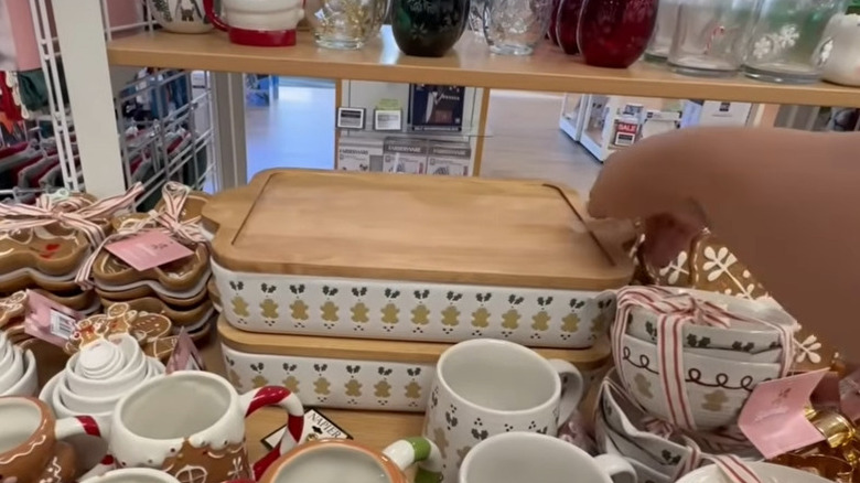 Man picking up gingerbread themed baking dish at Kohl's