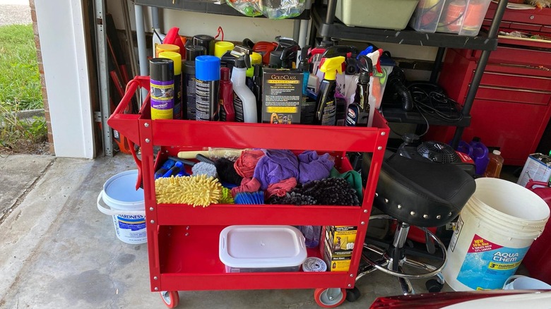 A service cart loaded with cleaning products.
