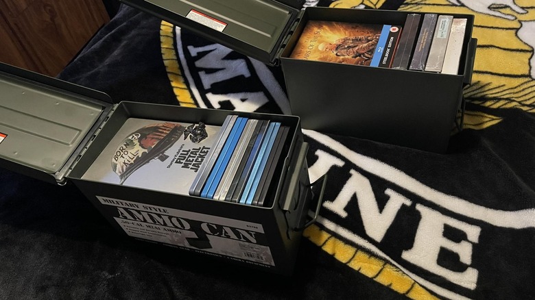 Film DVDs stacked inside metal ammo cans.