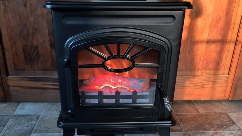 Close up of an electric heater that looks like a fireplace.