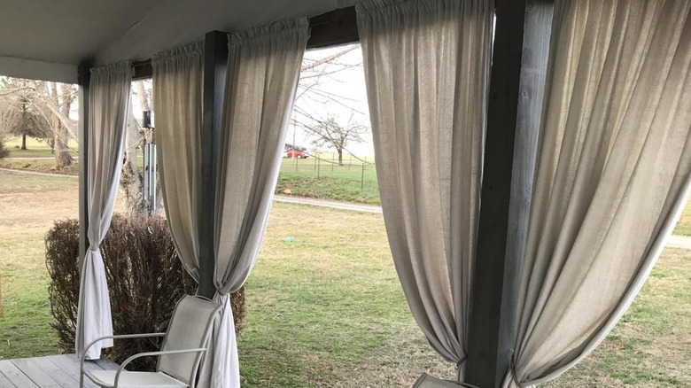 Canvas cloth as curtains around a patio.