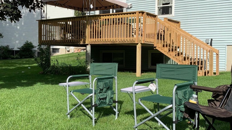 Green foldable chairs on the lawn.