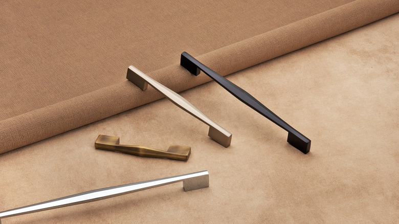 A selection of luxury metal drawer handles on a countertop