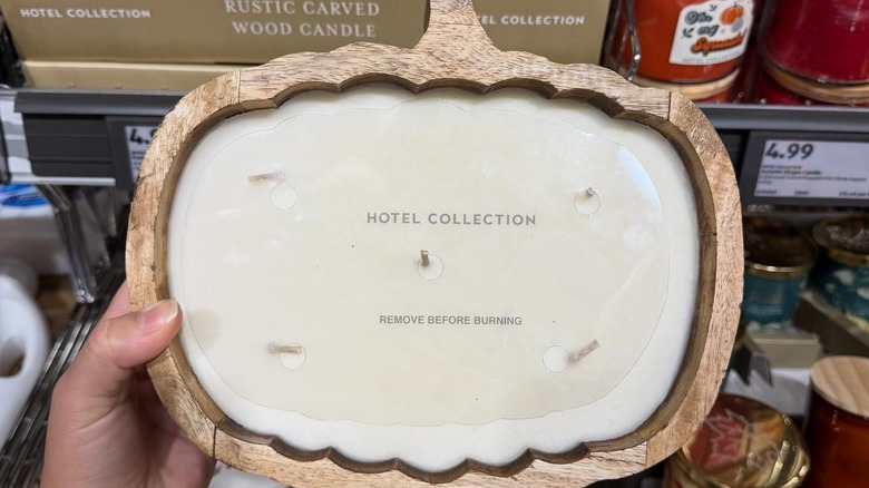 Pumpkin candle being held up in Aldi store