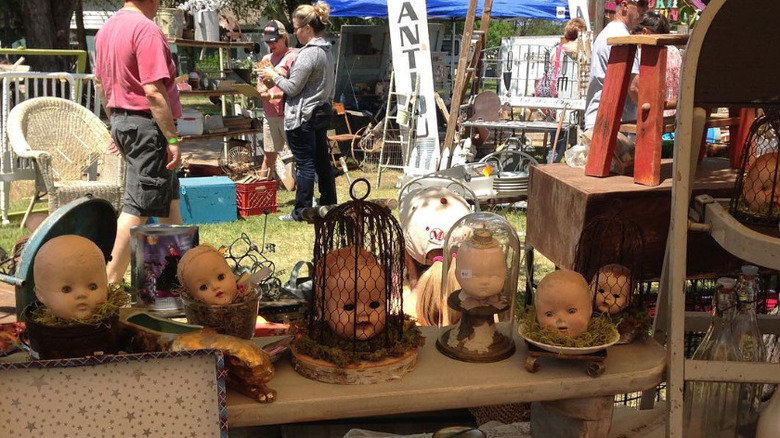 One vendor at the Old Chicken Farm with people shopping in the background.