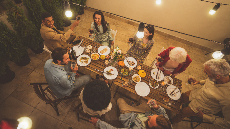 A group of friends enjoying time on together on a cozy, well-lit patio