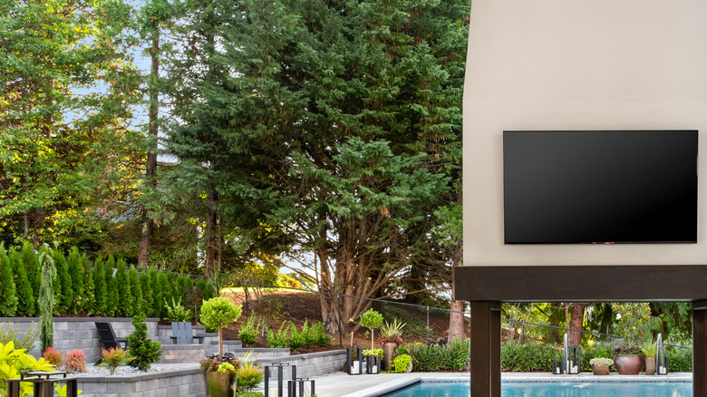 A luxury home patio with a TV on the wall