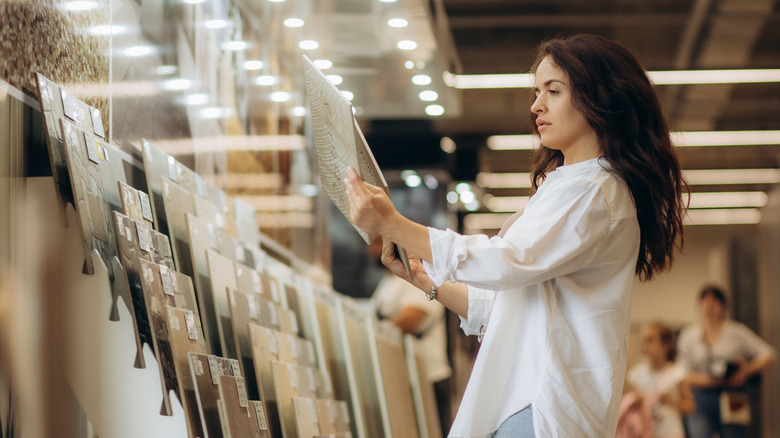 A person shopping for flooring at a home improvement store