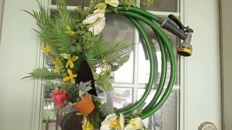 Wreath on a front door made from an old hose