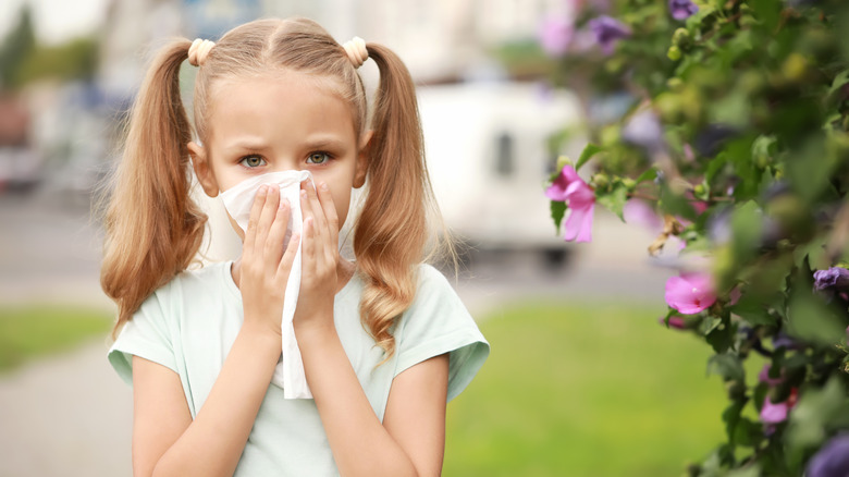 Young girl using tissue